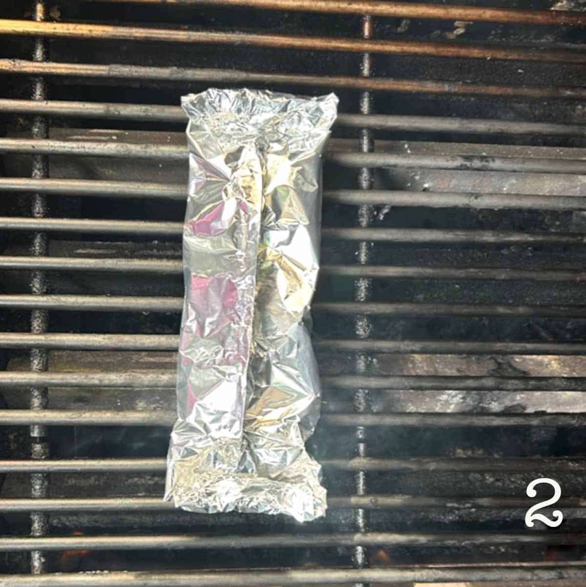 A foil packet on a grill.