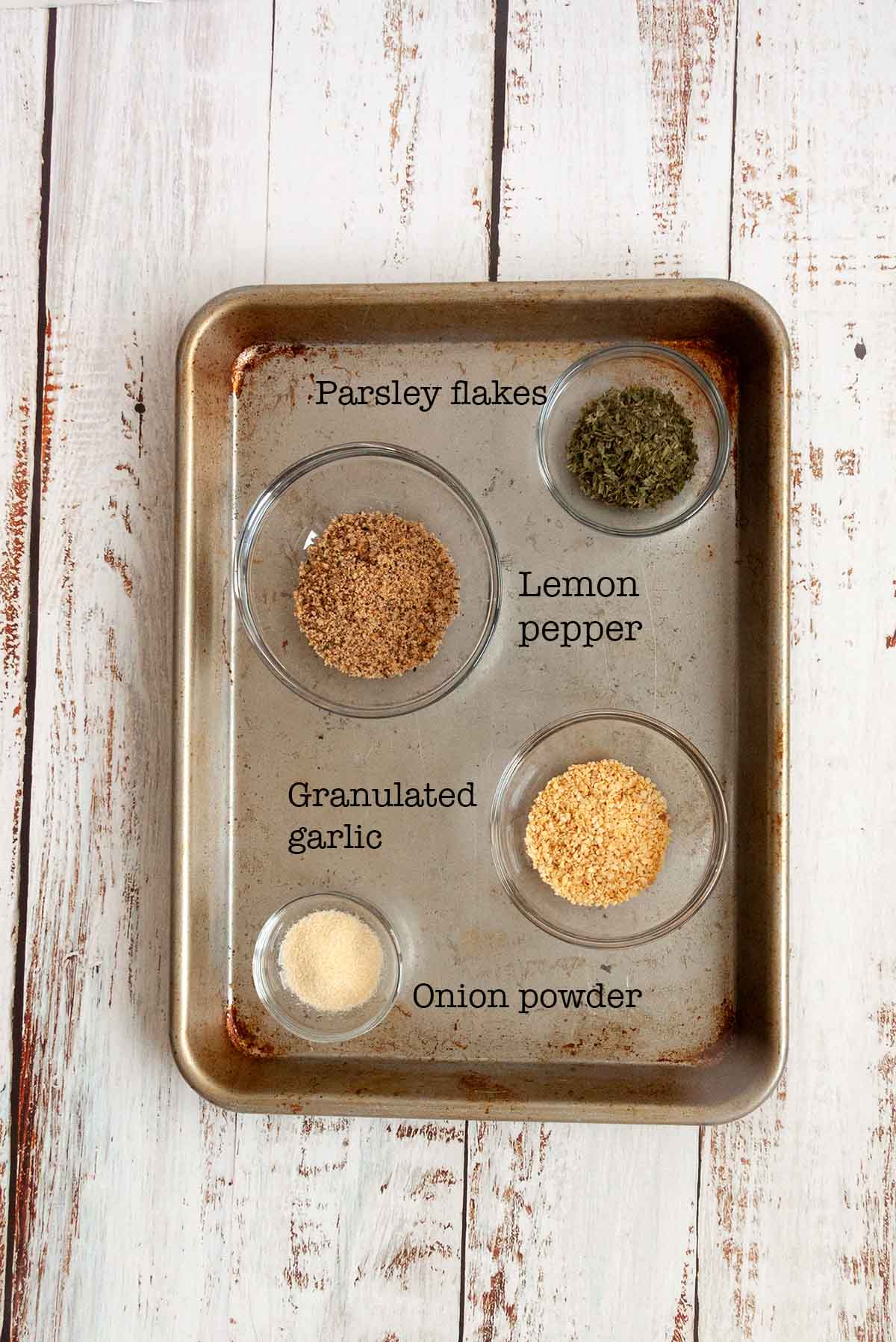 Ingredients for all-purpose seasoning blend--parsley flakes, lemon pepper, granulated garlic, and onion powder.