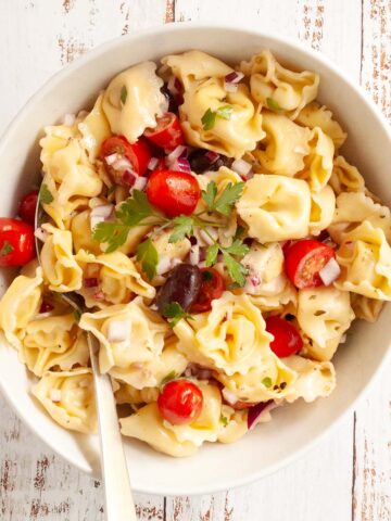 A white bowl filled with pasta salad.