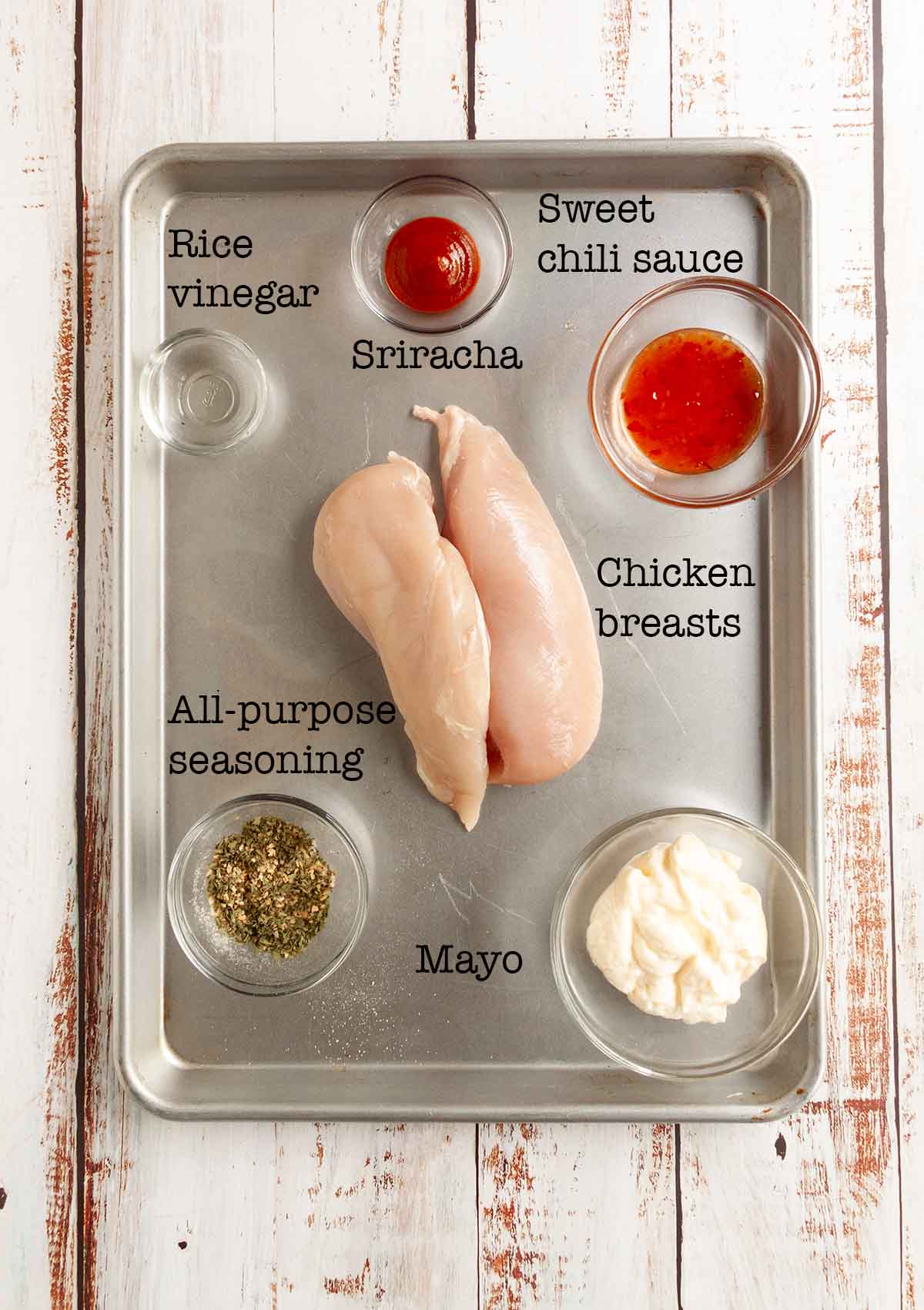 Ingredients for bang bang chicken skewers--chicken breast, rice vinegar, sriracha, chili sauce, seasonin, and mayo.