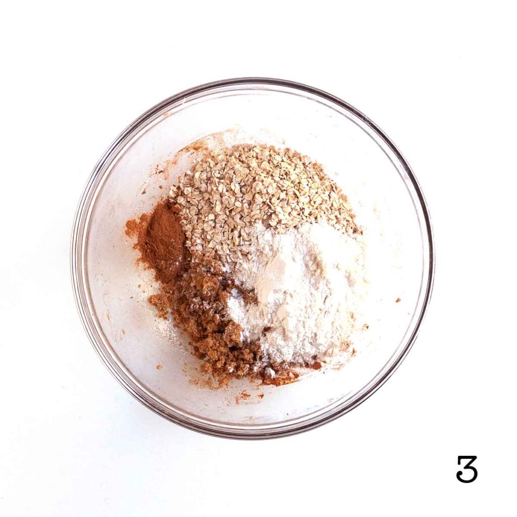 Flour, oats, cinnamon, and brown sugar in a glass bowl.