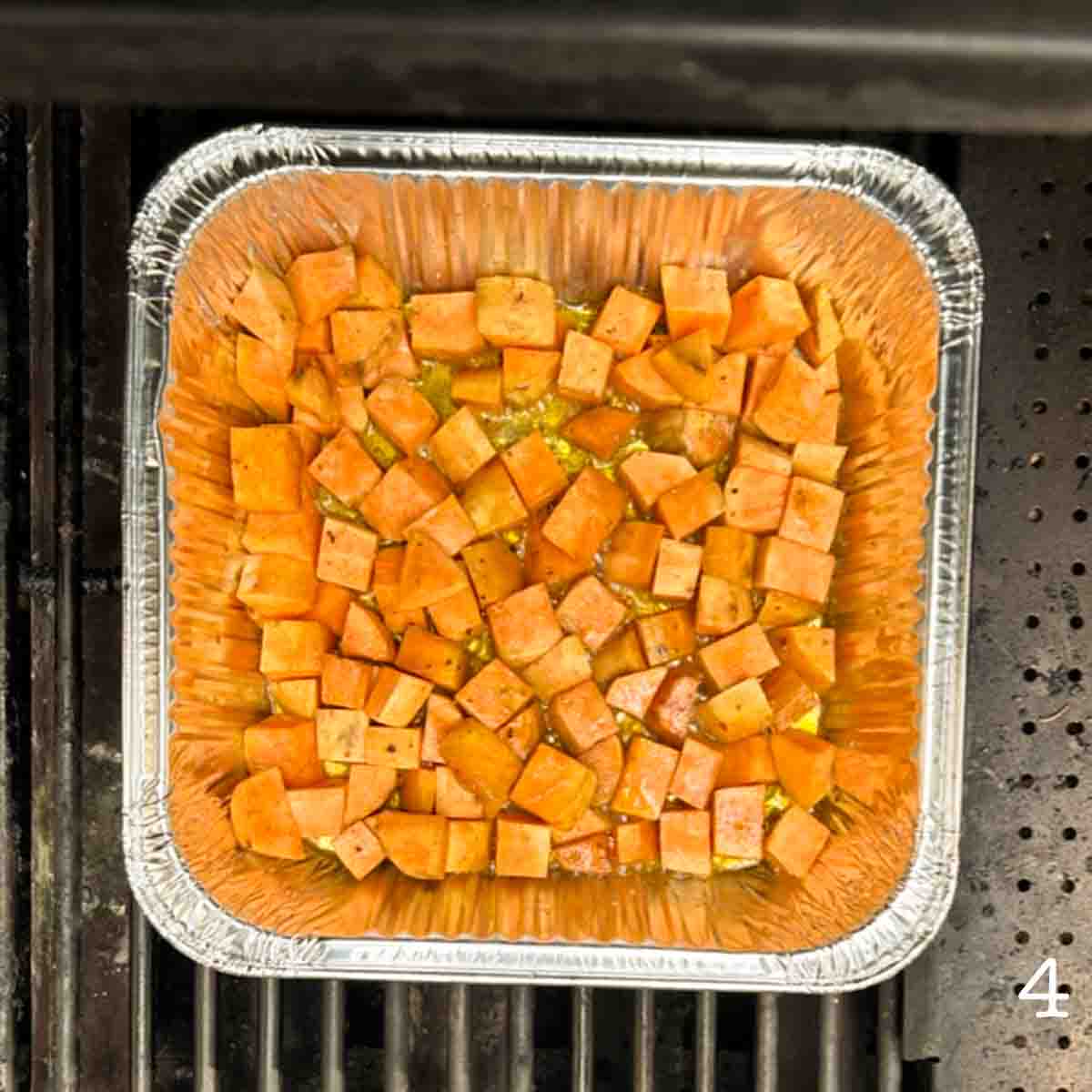 A tray of sweet potatoes on a grill.