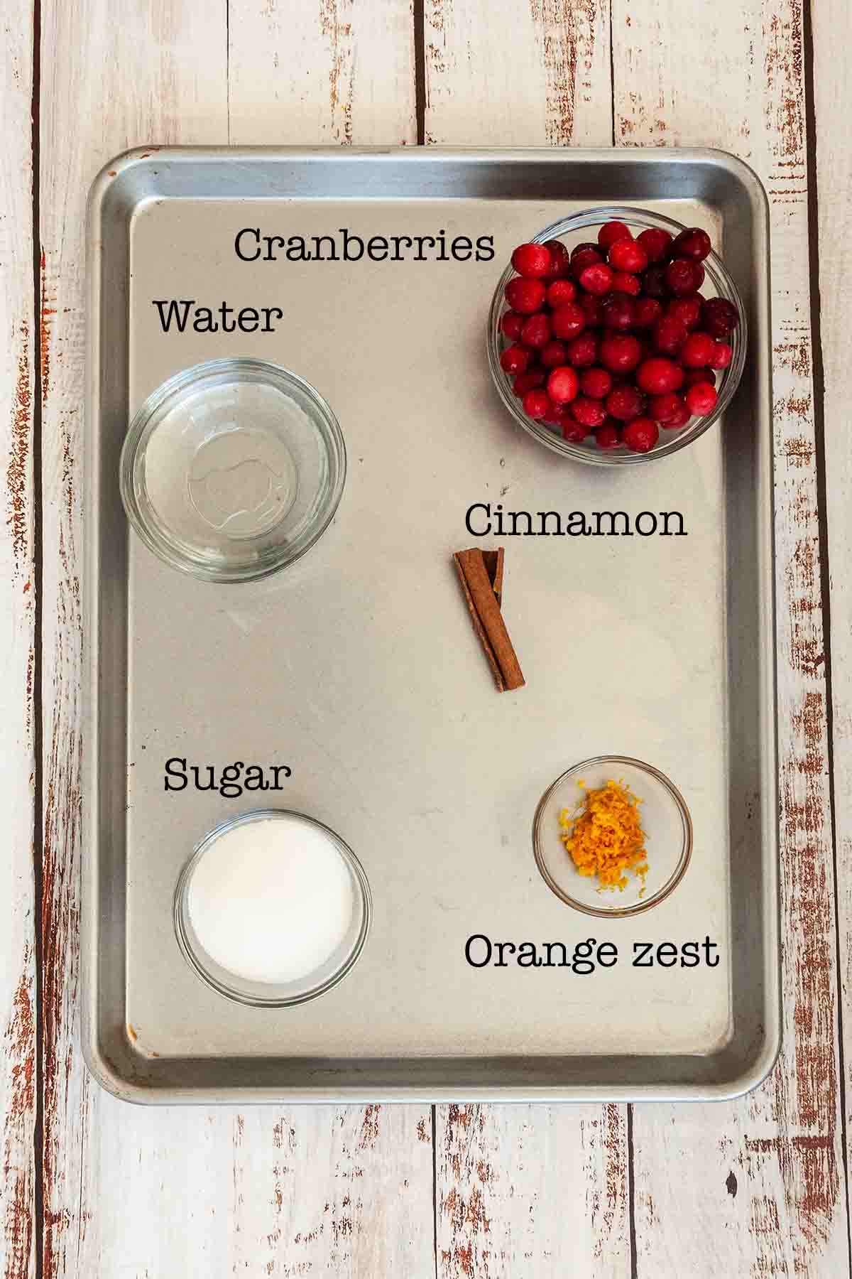 Ingredients for cranberry simple syrup--cranberries, water, cinnamon, sugar, and orange zest.
