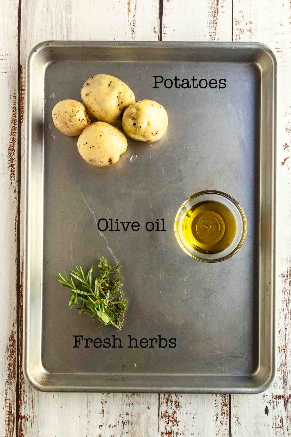 Ingredients for make-ahead roasted potatoes--potatoes, olive oil, fresh herbs.