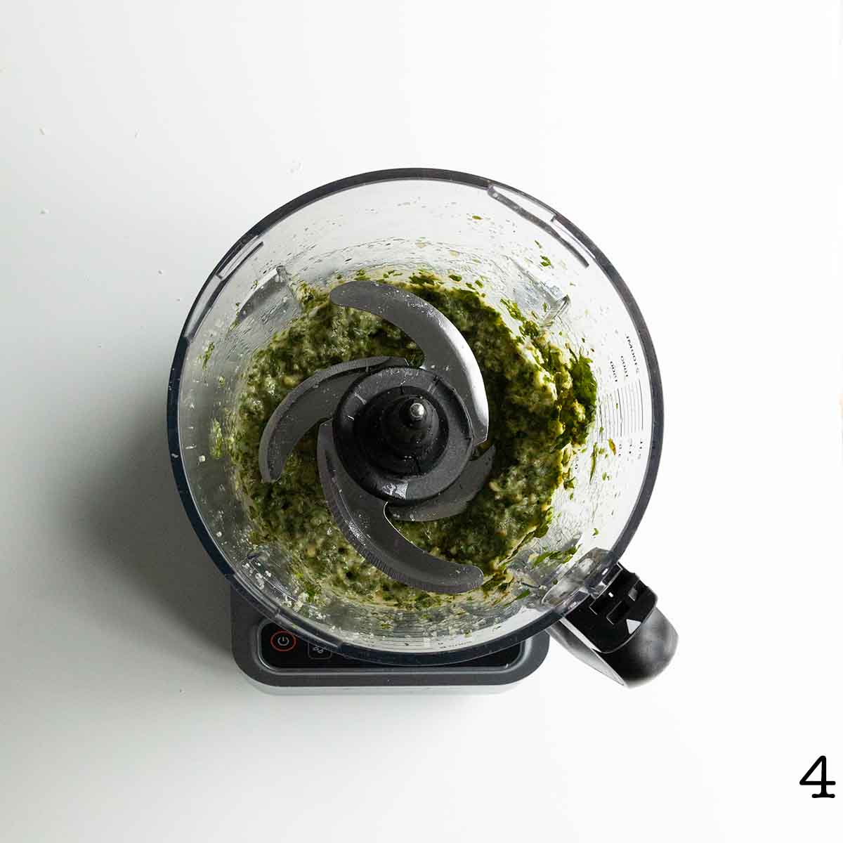 Blended pesto in a food processor.