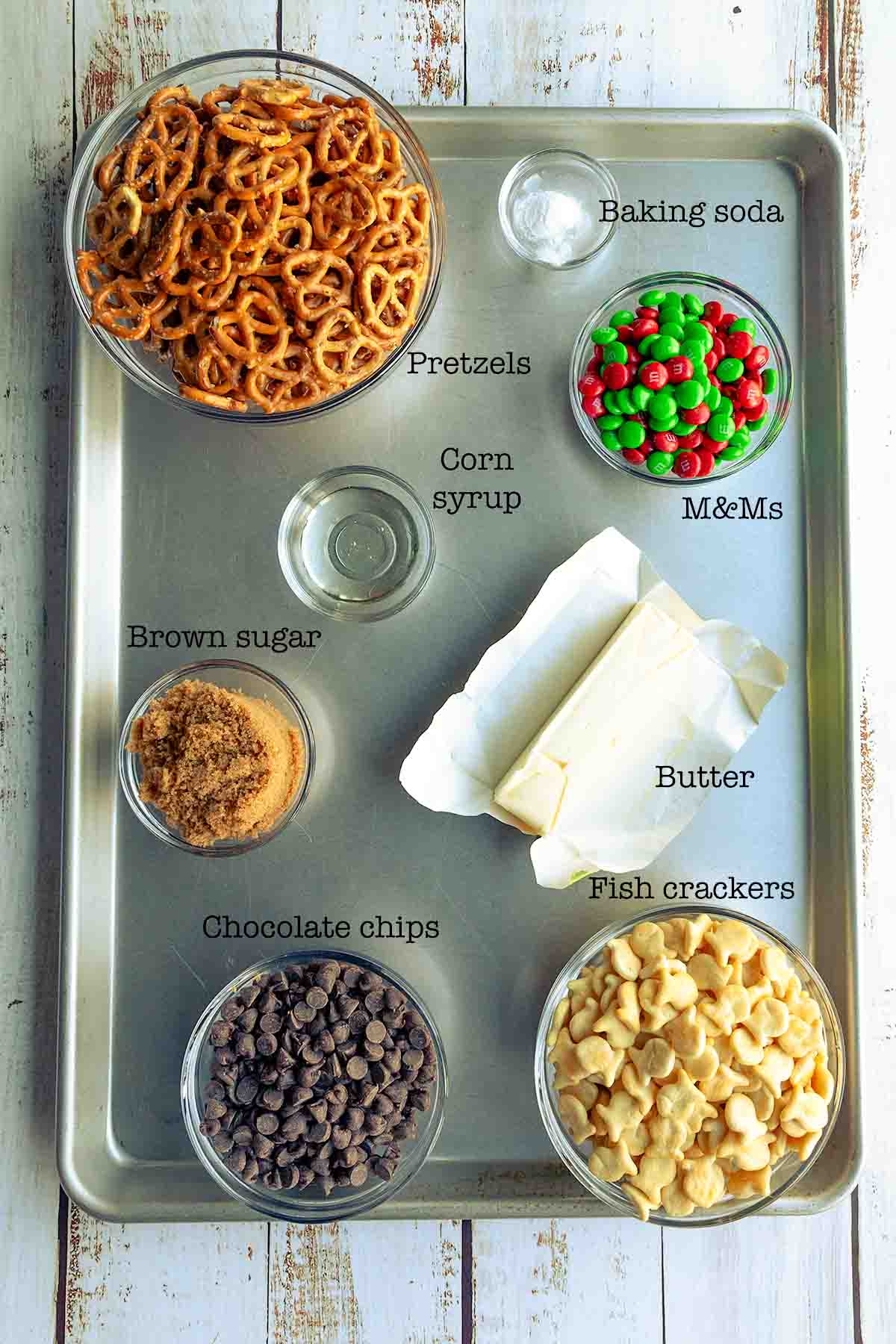 Ingredients for butter toffee trail mix--pretzels, baking soda, M&Ms, corn syrup, brown sugar, butter, chocolate chips, and fish crackers.