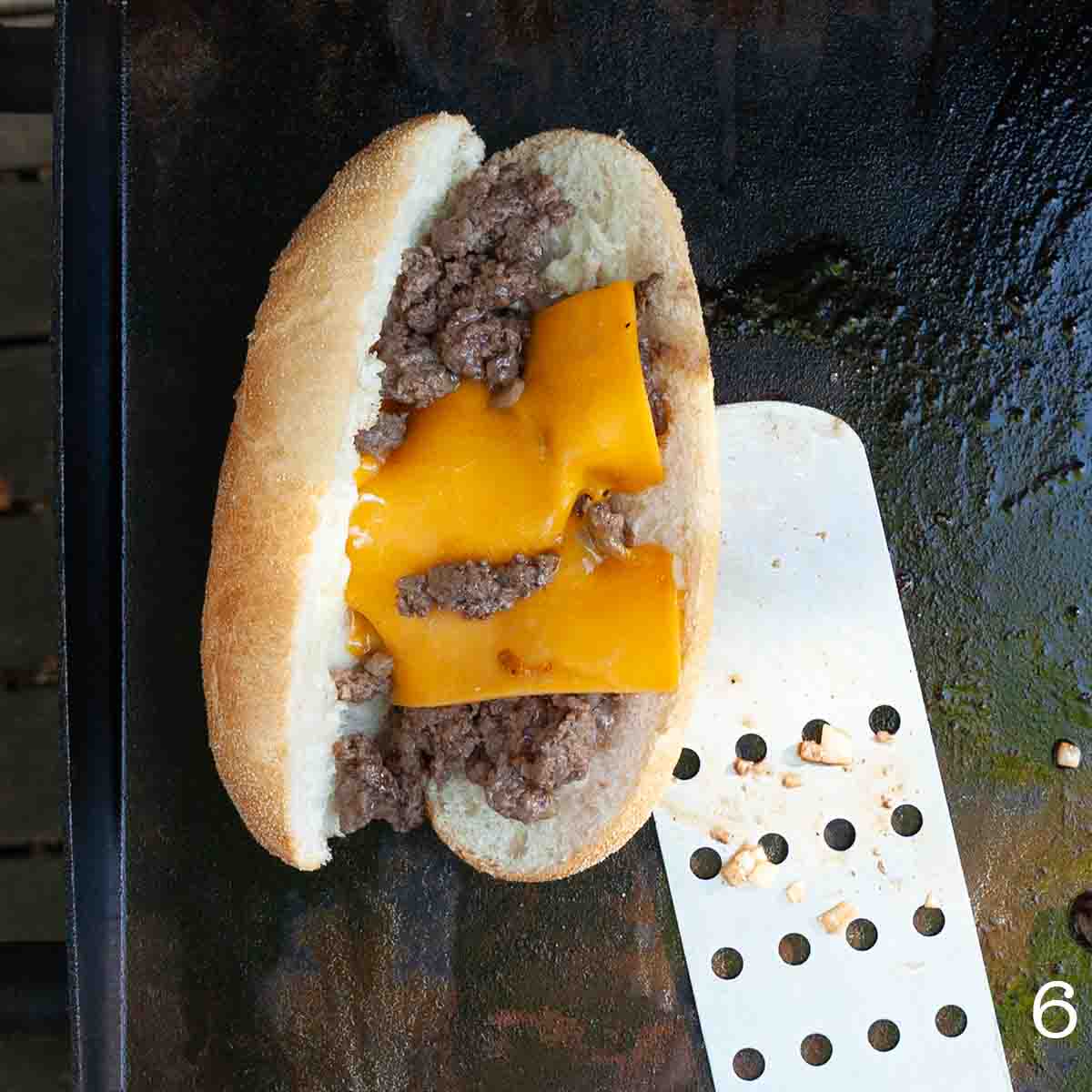 Ground beef and cheese on a bun.