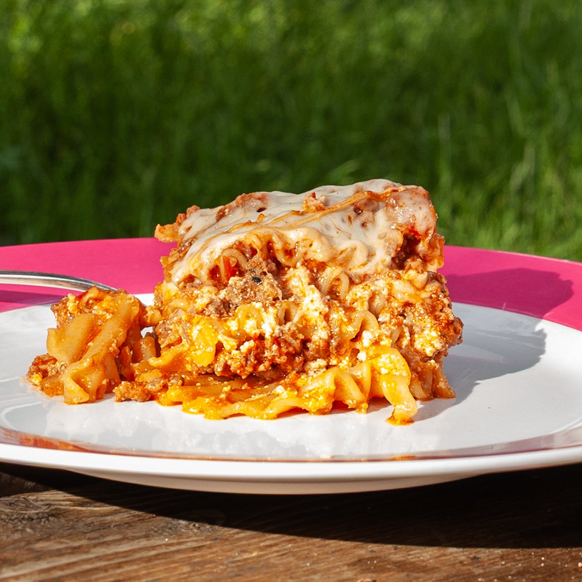 A slice of lasagna on a plate.