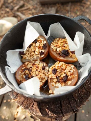 Four stuffed pears in a cast iron Dutch oven.