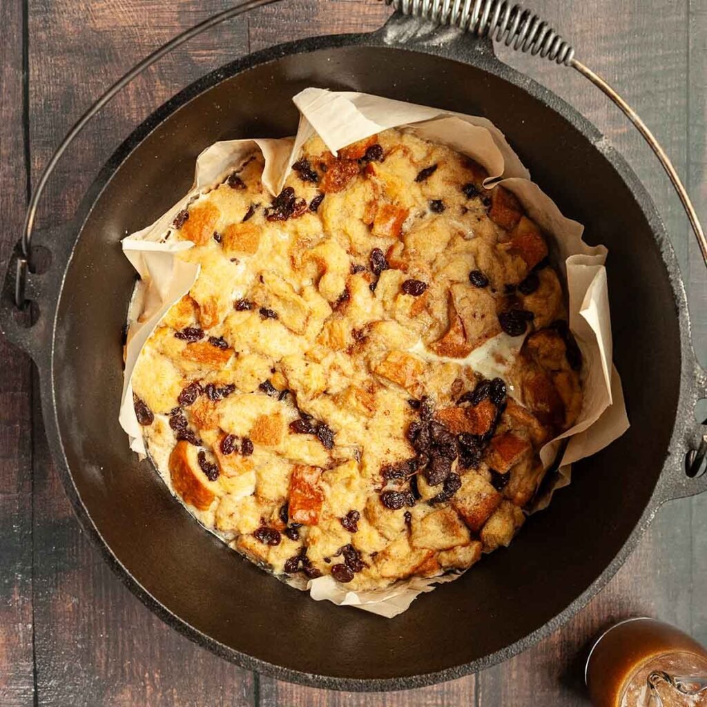 A cast iron Dutch oven filled with bread pudding.
