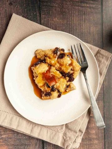 A serving of bread pudding on a plate.