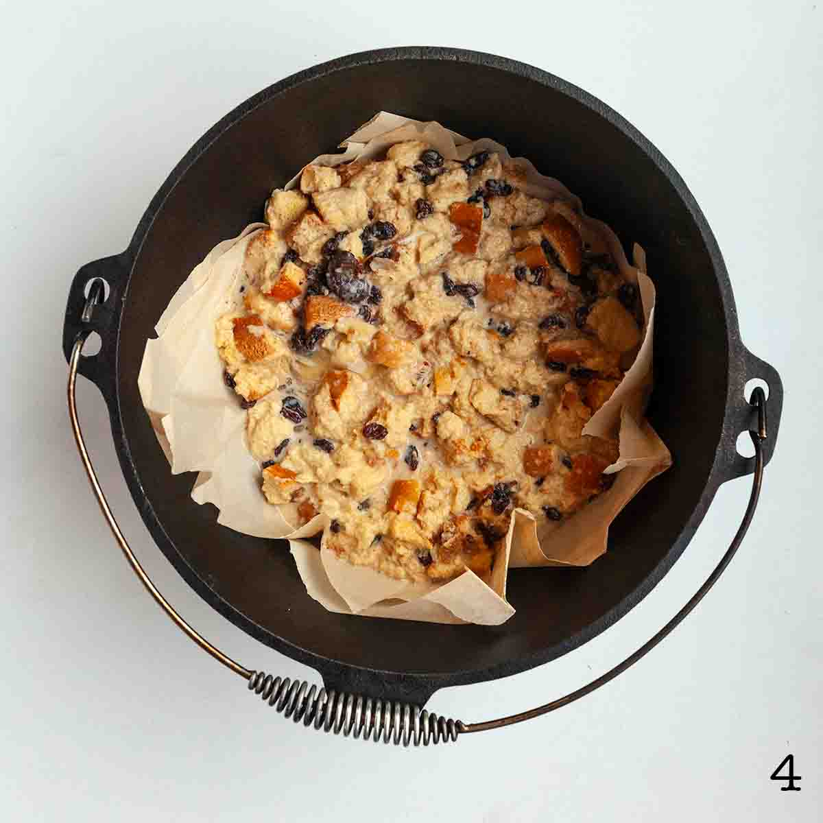 Uncooked bread pudding in a cast iron Dutch oven.