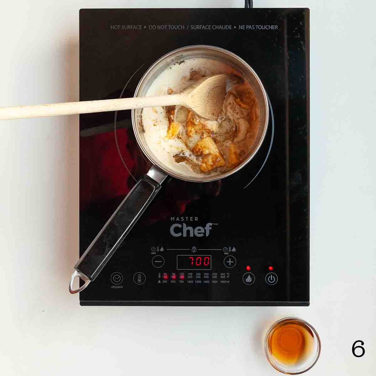 A pot of cream and butter on a burner.