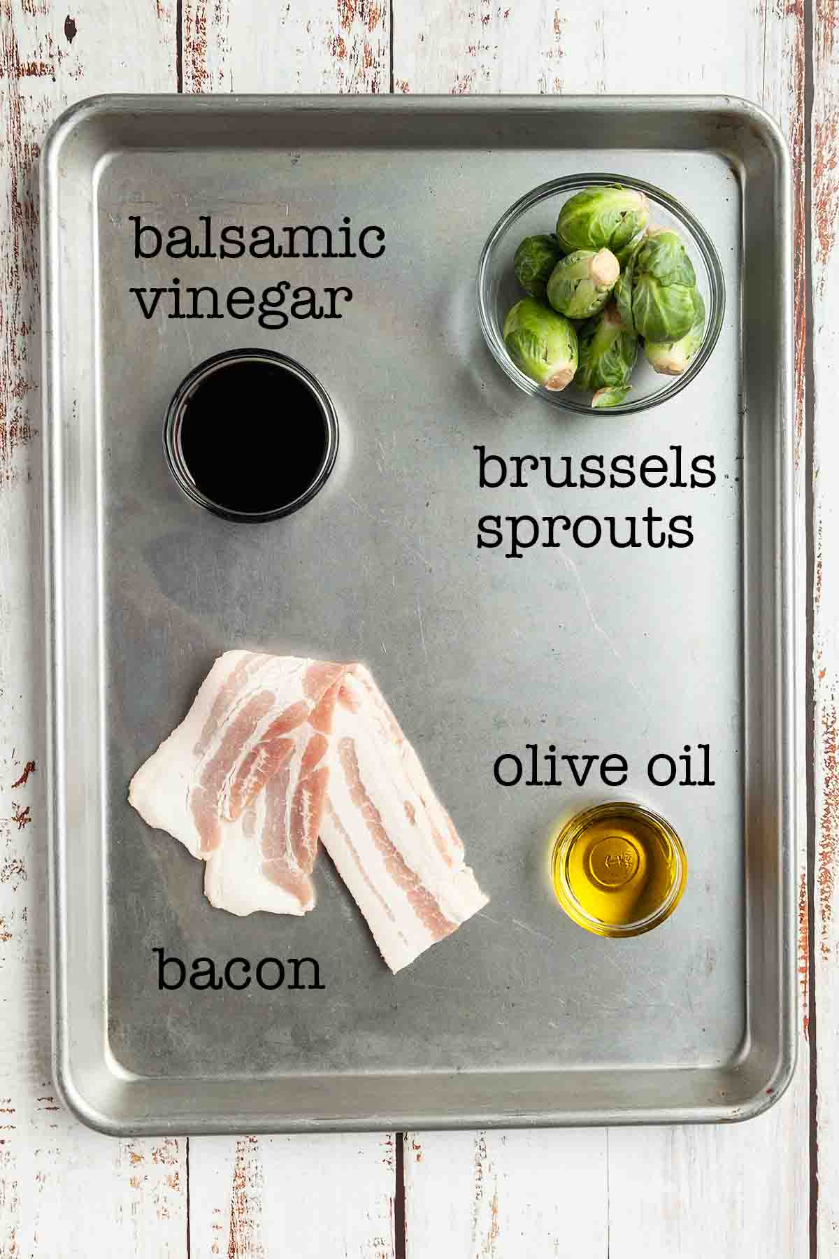Ingredients for grilled Brussels sprouts with bacon--balsamic vinegar, Brussels sprouts, olive oil, and bacon.