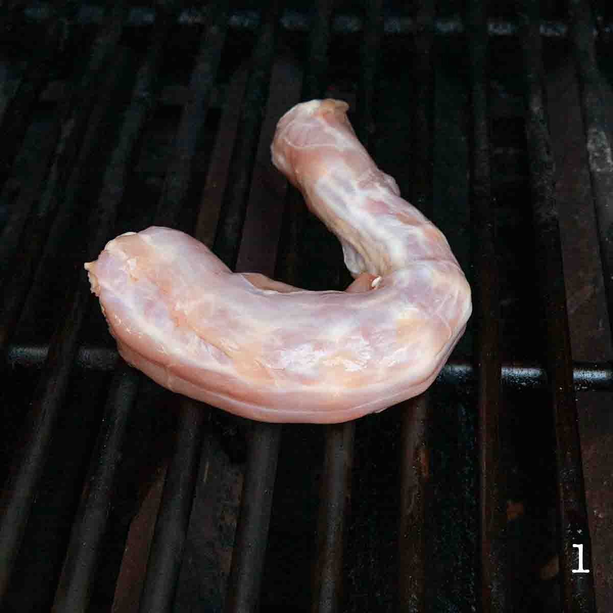A turkey neck on the grill.