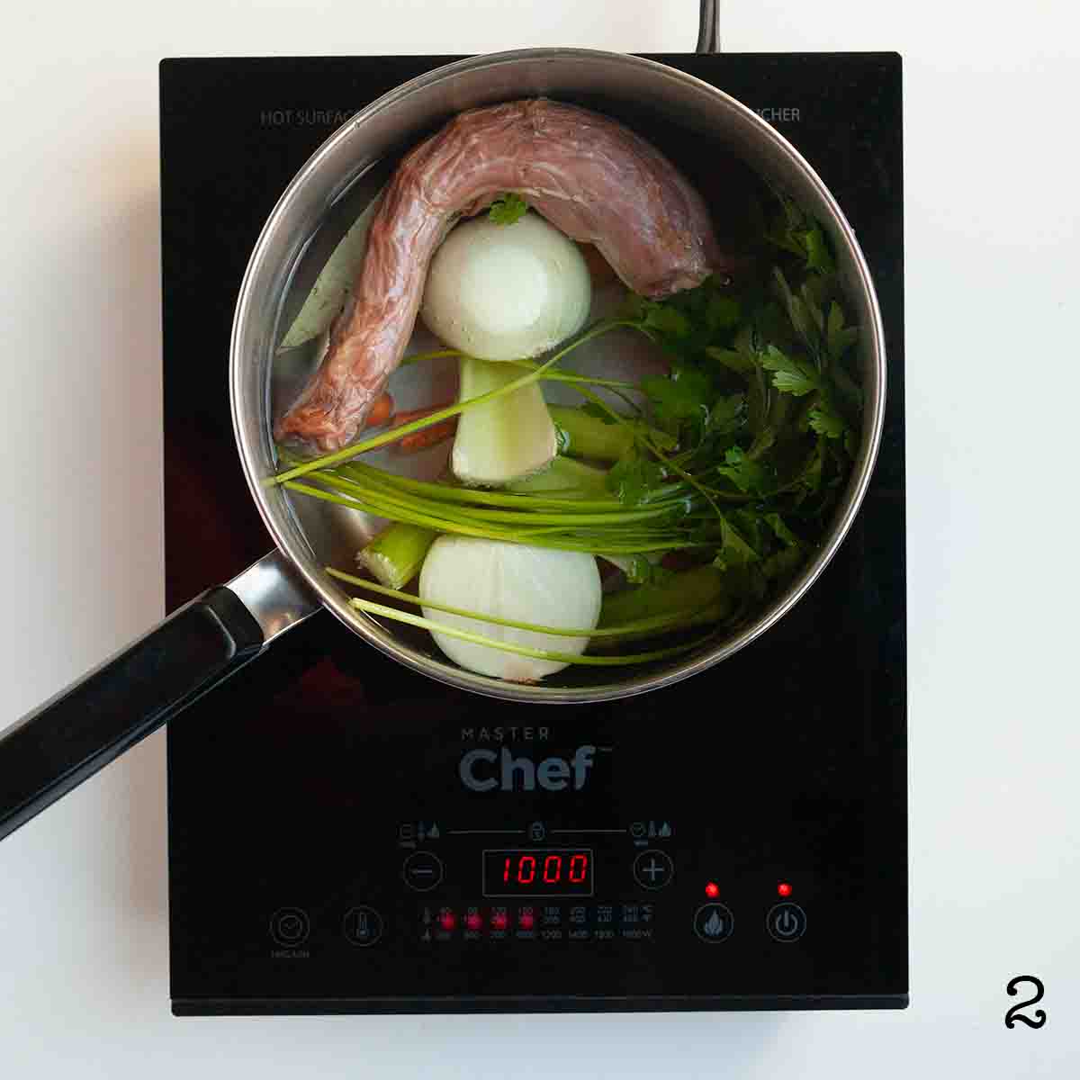 A pot filled with a turkey neck, vegetables, and water.