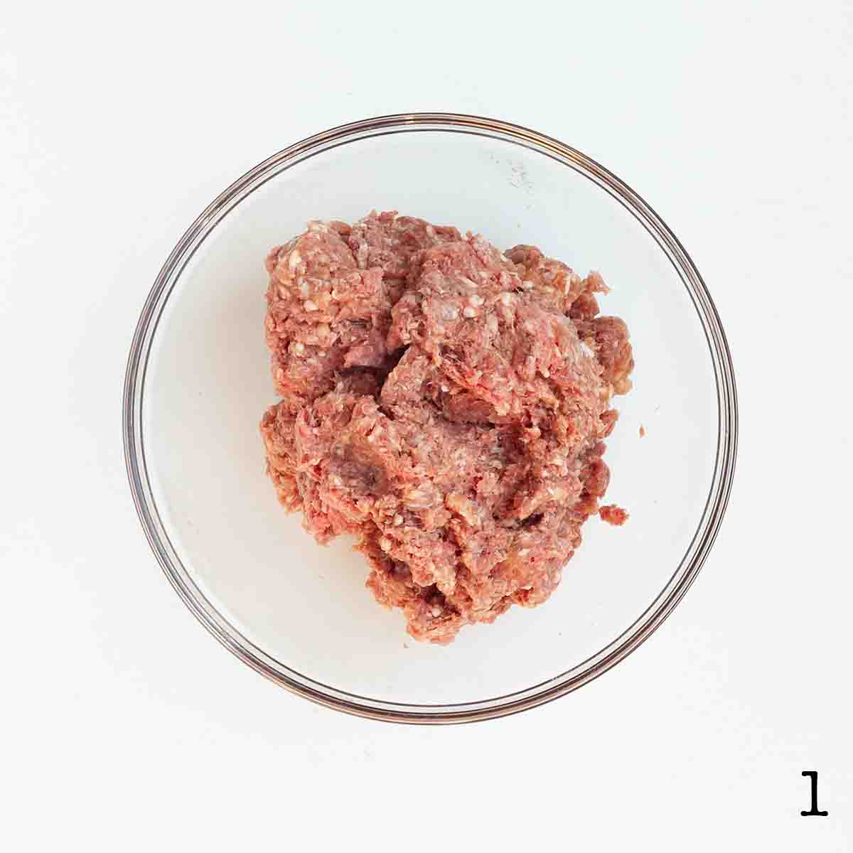 Ground beef and sausage mixed in a bowl.