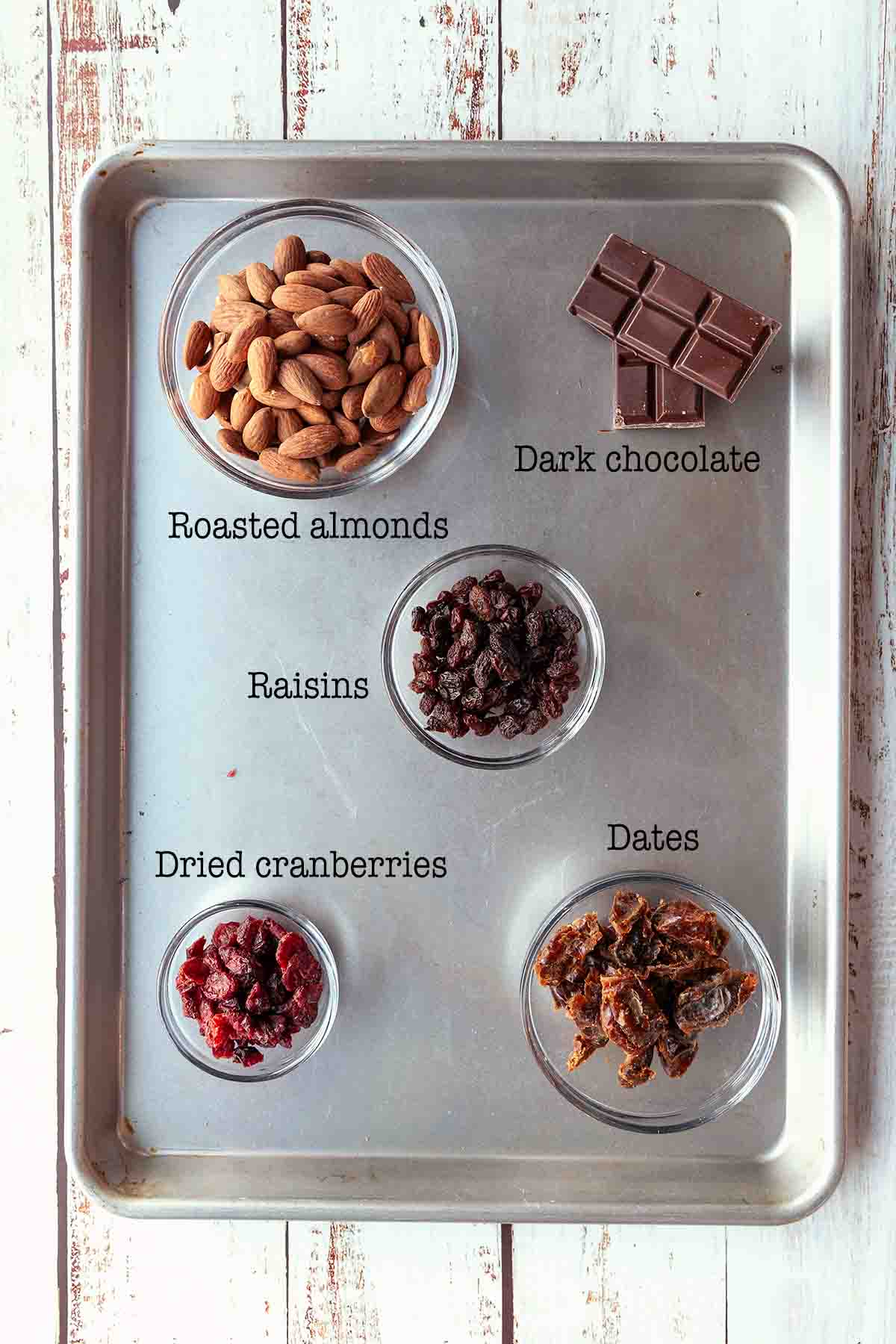 Ingredients for cranberry energy balls--roasted almonds, dark chocolate, raisins, cranberries, and dates.