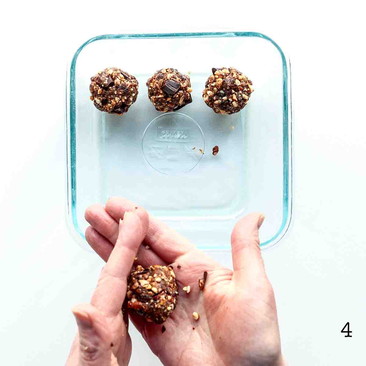 A person shaping energy balls.