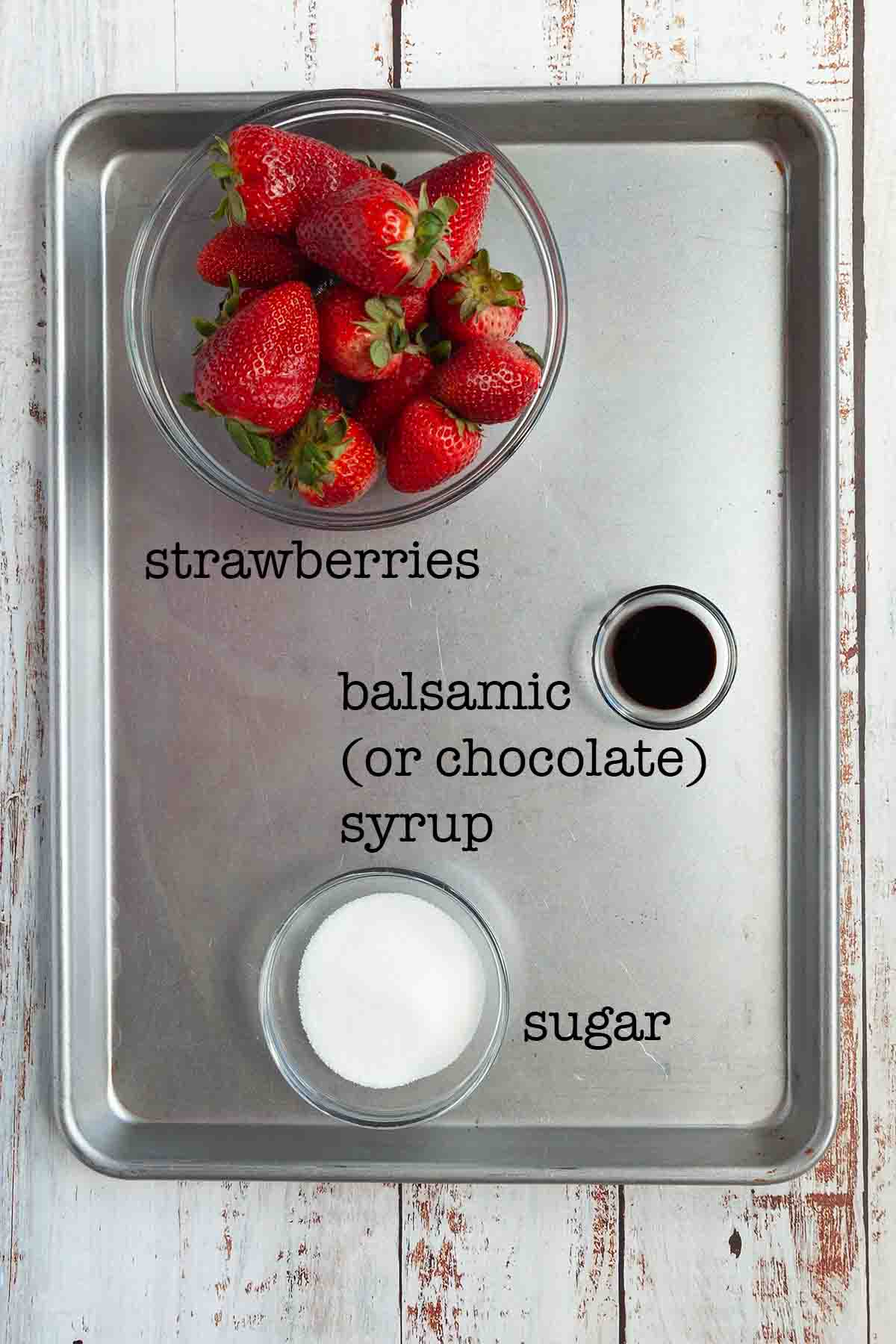 Ingredients for grilled strawberries--strawberries, sugar, and balsamic or chocolate syrup.