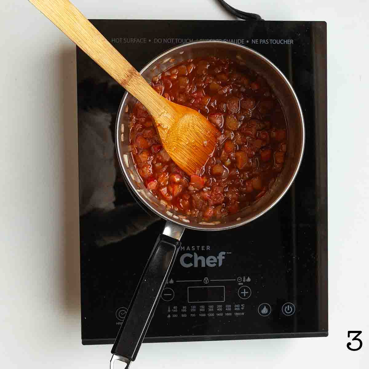 Cooked rhubarb in sauce in a pot.