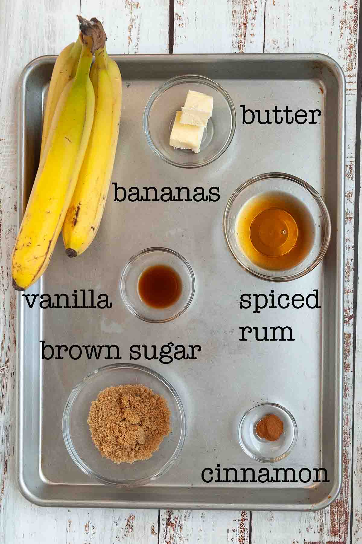 Ingredients for campfire bananas foster--bananas, butter, spiced rum, vanilla, brown sugar, and cinnamon.