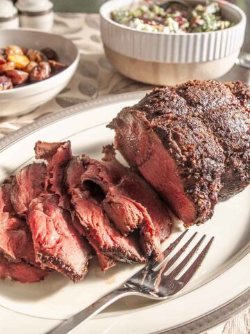 A partially sliced sirloin tip roast.