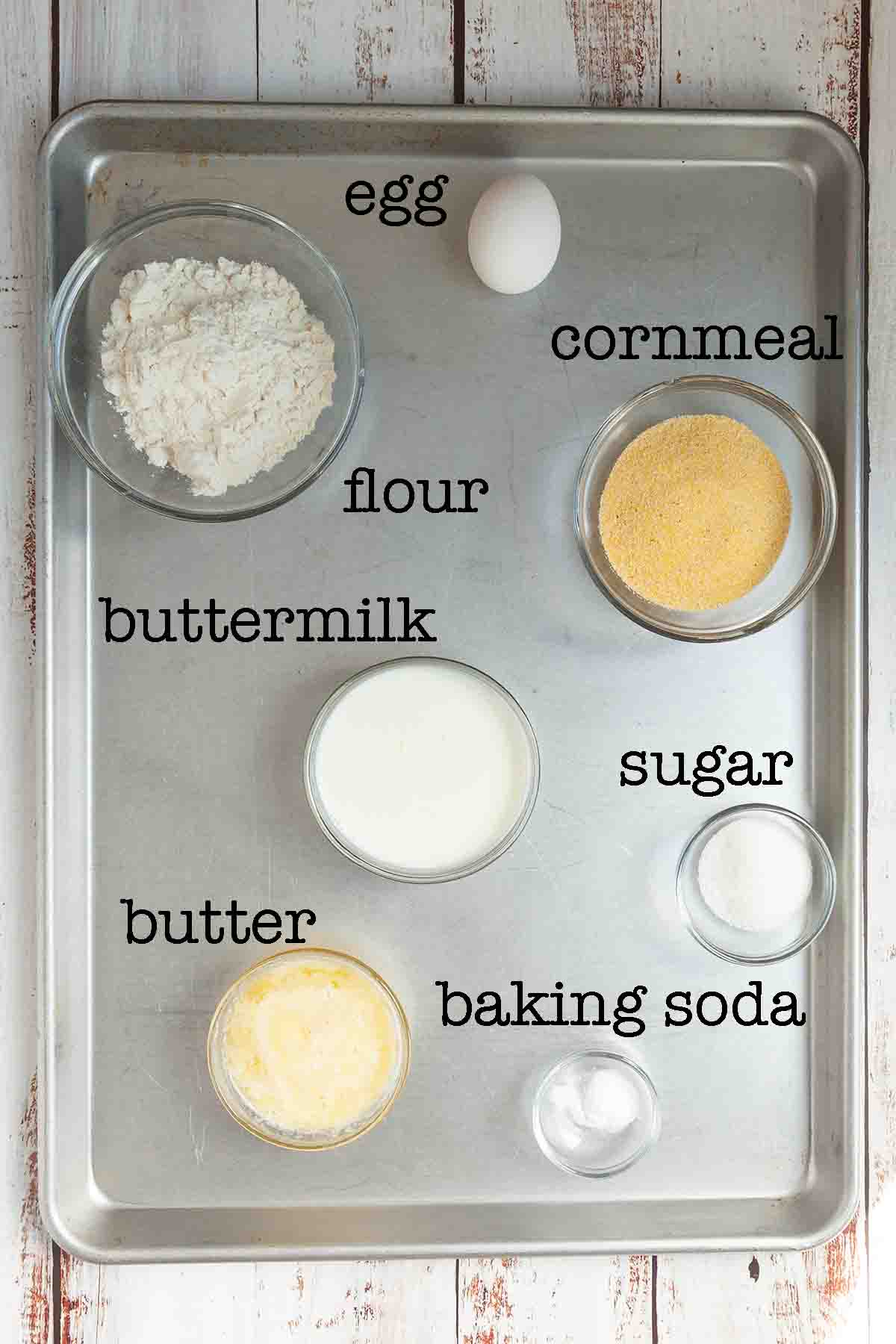 Ingredients for cornbread--flour, egg, cornmeal, buttermilk, sugar, butter, and baking soda.