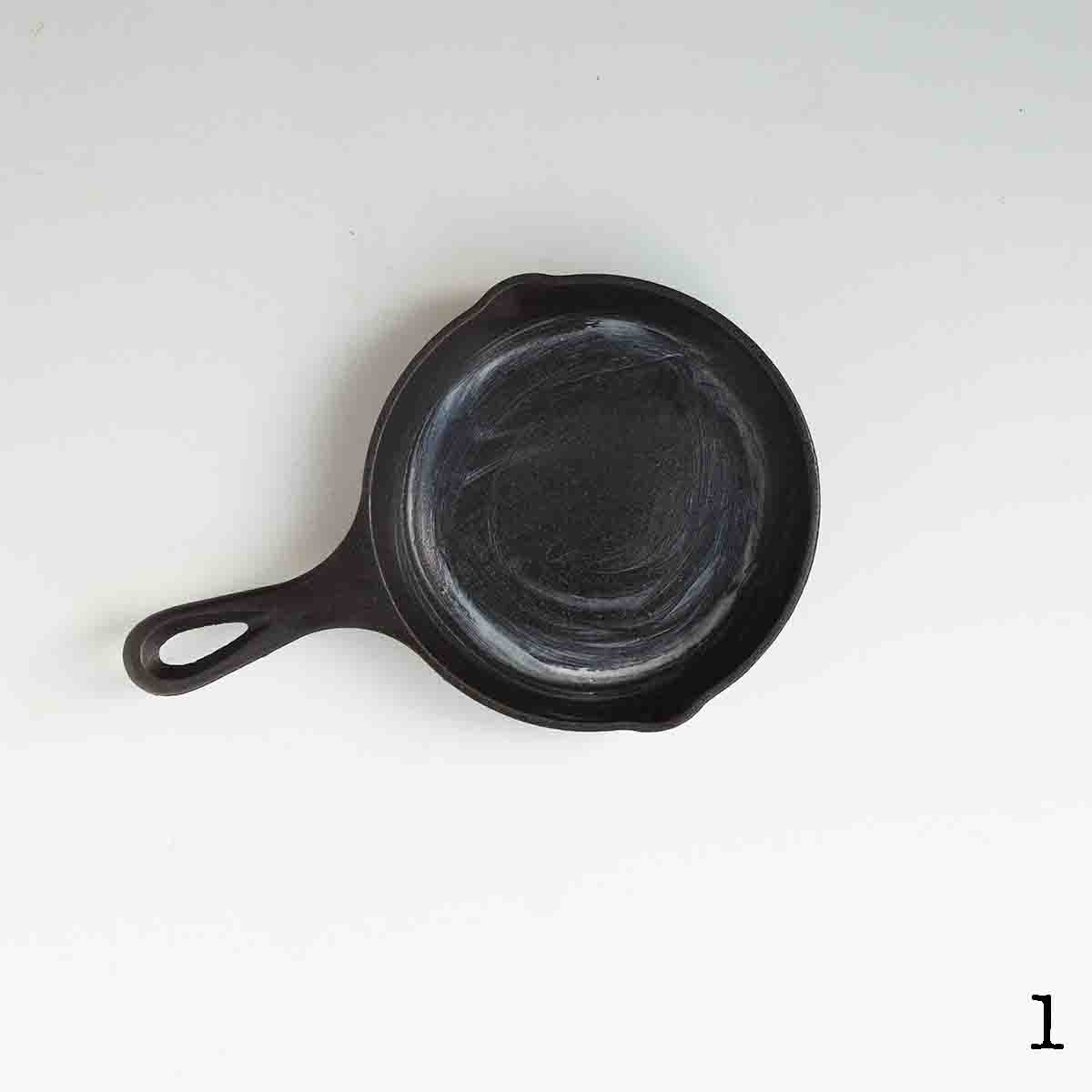 A buttered cast iron skillet.