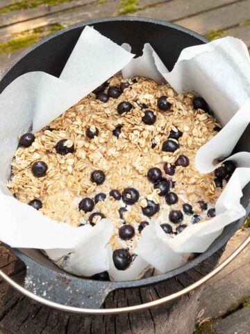 Baked oatmeal with blueberries in a cast iron Dutch oven.