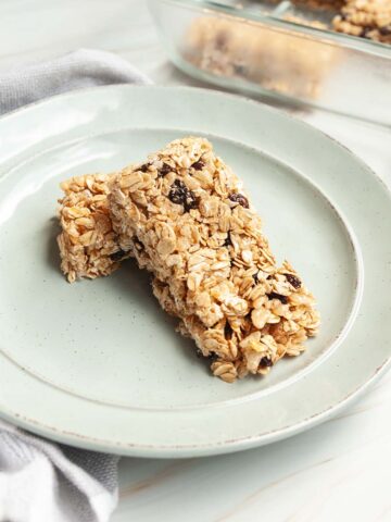 Two oatmeal raisin granola bars on a plate.