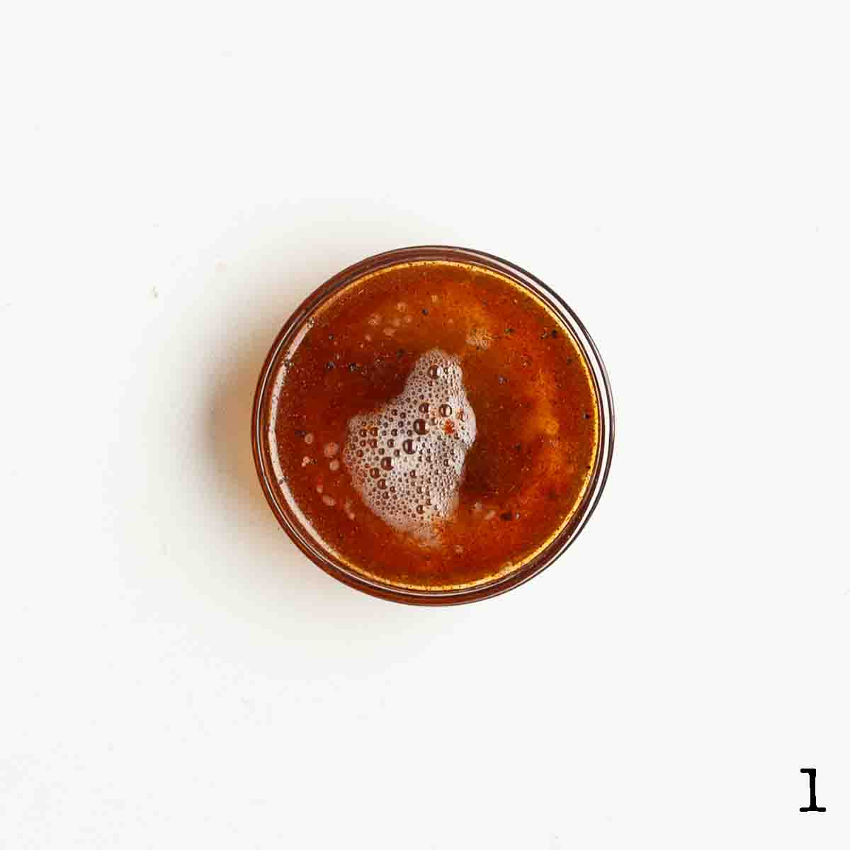 A bowl filled with dark brown liquid.