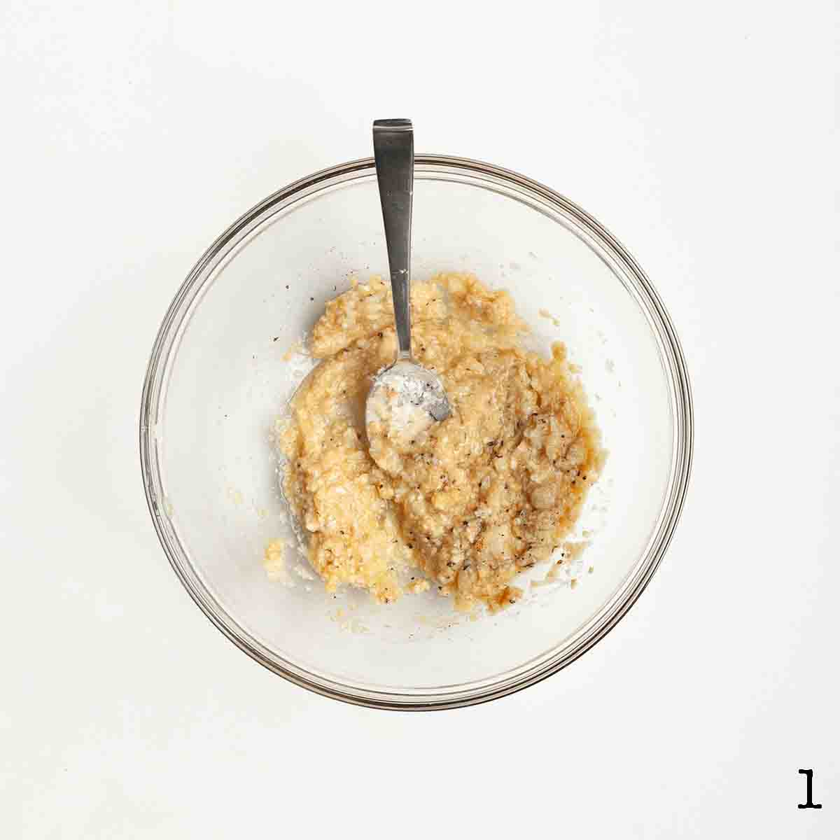 A bowl with a bread crumb paste mixture in it.