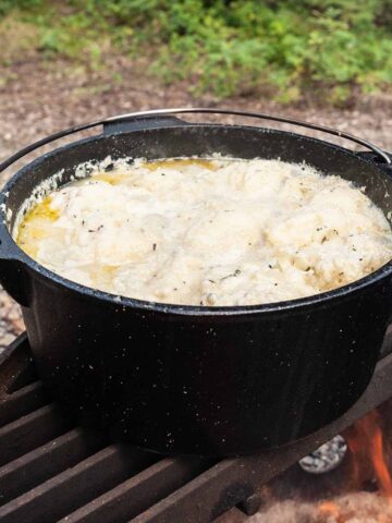 A large Dutch oven filled with chicken and dumplings.