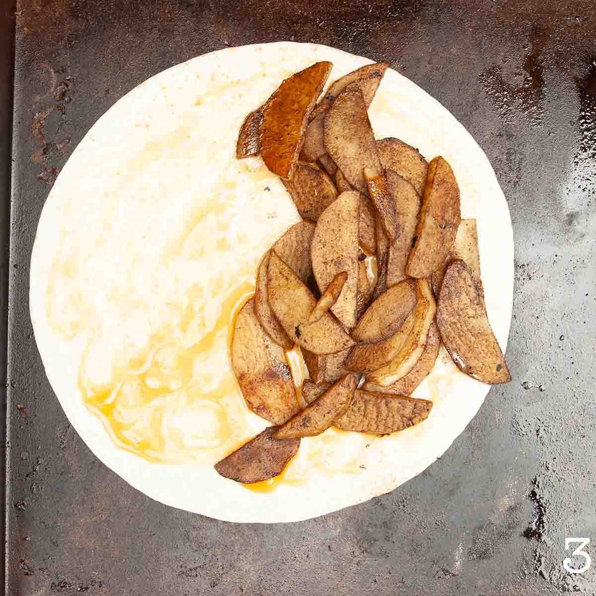 A partially assembled apple quesadilla.